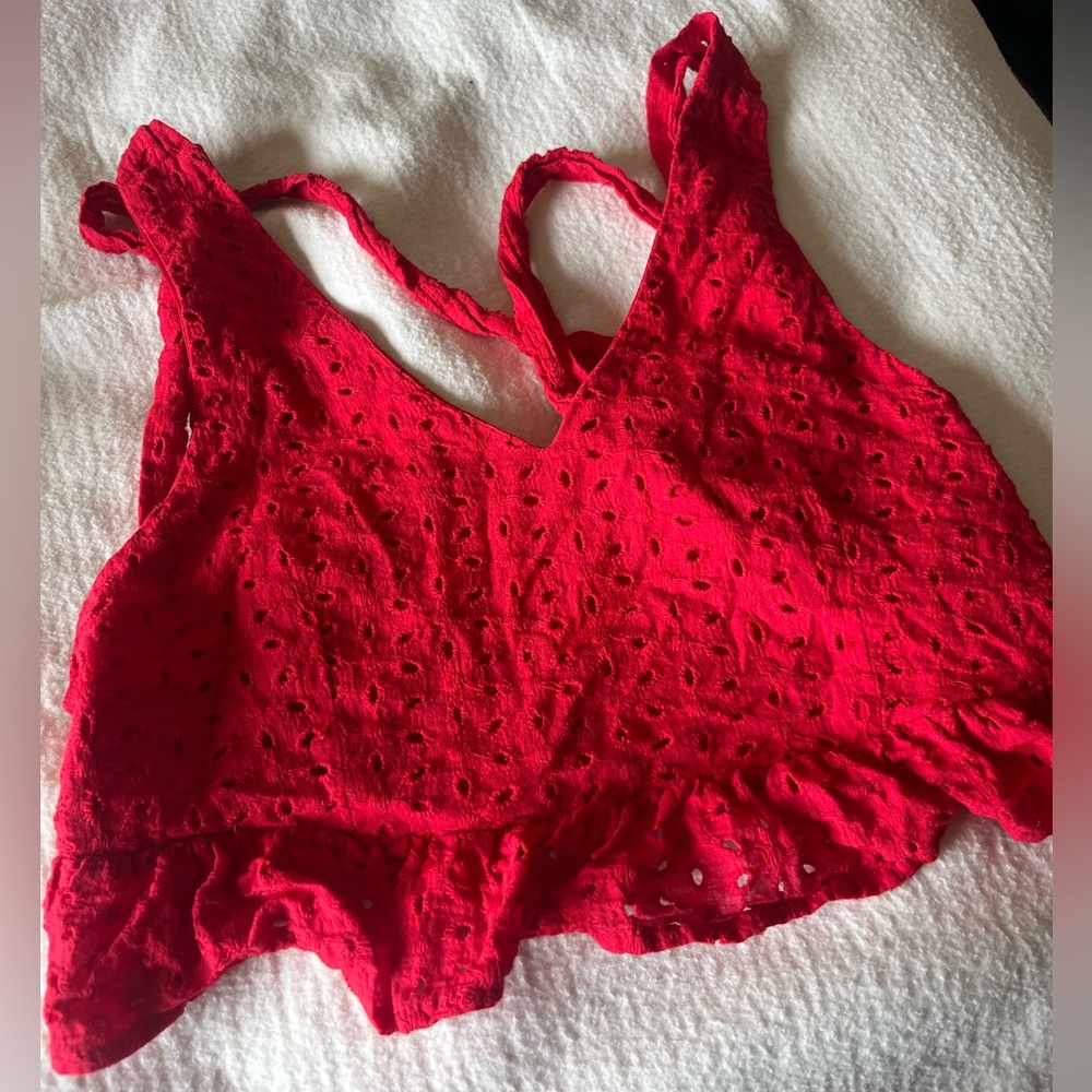 Super cute XS red crop top. Ties in the back and has ruffles going across it!